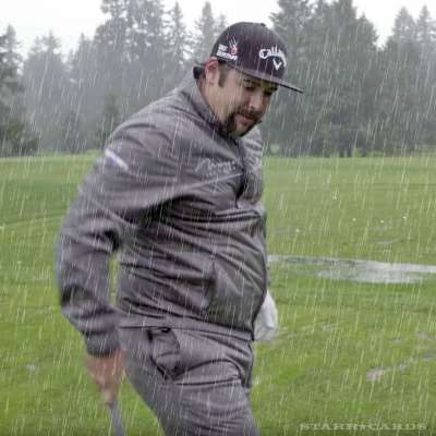 Andres Gonzales golfing in the rain