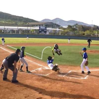 Base runner Mighty Mouse leaps catcher to score a run