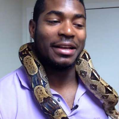 Yasiel Puig with a snake around his neck while visiting the Cincinnati Zoo.